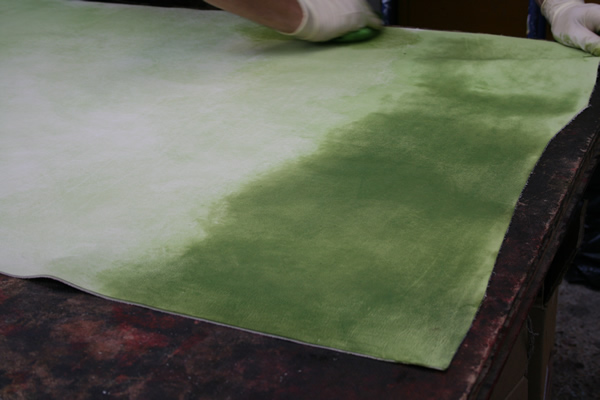 Base coat staining of leather